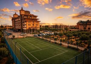 a tennis court in front of a building at Casablanca Hotel - All Inclusive in Obzor