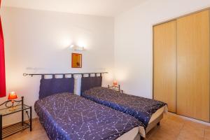 a bedroom with two beds in a room at Le Figuier - La Fontinelle in Bessas +26 photos