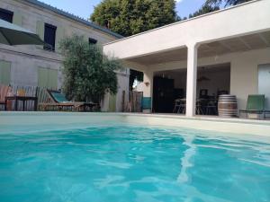a swimming pool in front of a house at la caquetoire in Les Églisottes-et-Chalaures