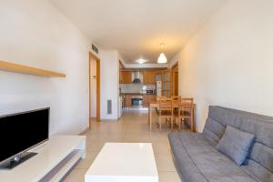 a living room with a couch and a table at Torredembarra in Torredembarra