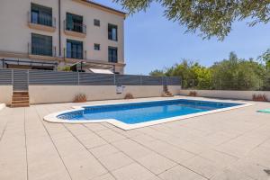 a swimming pool in front of a building at Torredembarra in Torredembarra