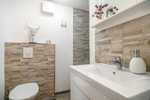 a bathroom with a white sink and a toilet at Eifel-Dream Kalkmulde in Fleringen +18 photos