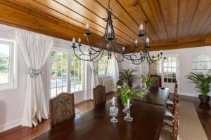 a dining room with a table and a chandelier at Quinta do Cabo Guesthouse in Sintra