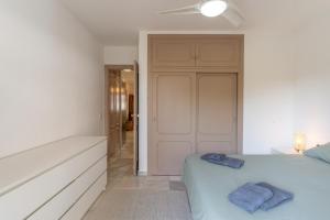 a bedroom with a bed with two towels on it at Sunny Calahonda Park in Sitio de Calahonda +15 photos