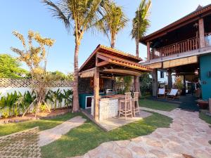 a patio with a bar in the backyard of a house at Beachview Villa near Sanur, Live Sports AFL NRL in Ketewel
