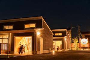 a building with a motorcycle in front of it at night at POPFIRE TOWN in Shirako
