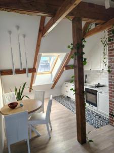 a kitchen and dining room with a table and chairs at Pliusas Residence in Jurbarkas