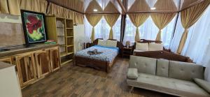 a living room with a bed and a couch at Cool Waters Jungle Villas in Uvita