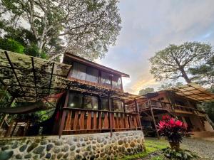 a house with a wrap around porch with windows at Cool Waters Jungle Villas in Uvita