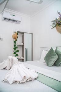 a bedroom with a bed with a towel on it at Mbuyu Taifa Greenview Mlandege Apartment in Zanzibar City