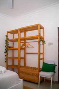 a wooden bunk bed in a room with a chair at Mbuyu Taifa Greenview Mlandege Apartment in Zanzibar City +13 photos