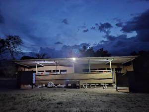 a building with a light on the roof at night at Hennies HideOut in Kachikau