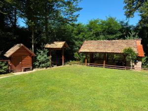 a pavilion and a gazebo in a yard at Dunja Cabin - Forest House with Pool in Banja Luka