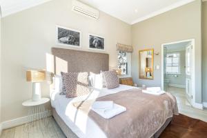 a bedroom with a large bed in a room at Winelands Golf Lodges 2 in Stellenbosch +71 photos