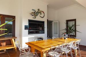 a dining room with a wooden table and chairs at Winelands Golf Lodges 2 in Stellenbosch