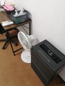 a box with a fan next to a table at 駅舎泊ラッセルイン in Hirakawa