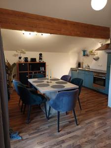 a kitchen with a table and chairs in a room at Lodge Ehrenberg in Ehenbichl