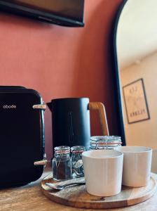 a table with two cups and a coffee maker at The Five Bells Inn Accommodation in Claypole