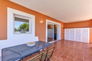 a dining room with a table and chairs at Son Bou Pool and Sea in Son Bou +14 photos