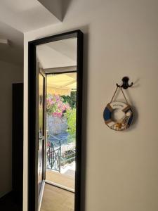 a mirror on a wall next to a door at Seafront Apartment Strunjan in Strunjan