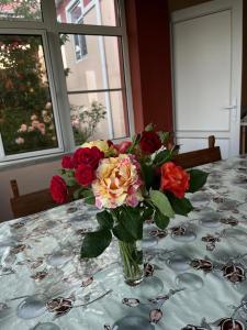 a vase of flowers sitting on a table at Quba Guest House in Digah +22 photos