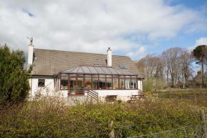 a large white house with a lot of windows at Leanach Farm in Inverness