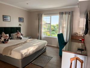 a hotel room with a bed and a window at Blue Bend Valley in East London +58 photos