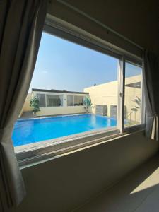 a view of a swimming pool through a window at Cafe Itaewon Pool & Villa in Sampong