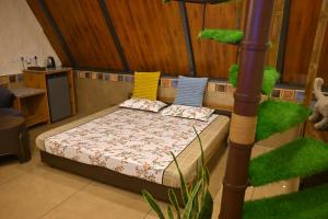 a bedroom with a bed with colorful pillows on it at Coco Homes Katra in Katra
