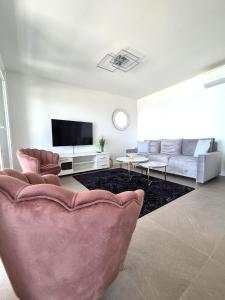 a living room with a couch and a tv at Miami in Veliko Brdo