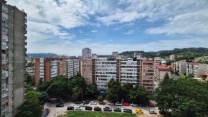 a city with cars parked in a parking lot at MyPlace apartmani 42,56,70 in Tuzla