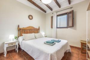 a bedroom with a white bed and a window at Casa Villazo 1 in Málaga +32 photos