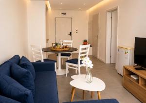 a living room with a blue couch and a table at Casablanca Hotel - All Inclusive in Obzor