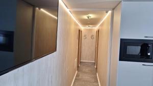 a hallway with a television and a hallway with a hallway sidx sidx at Sleep House in Labin