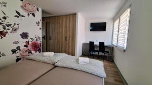 a bedroom with a bed with flowers on the wall at Sleep House in Labin +2 photos