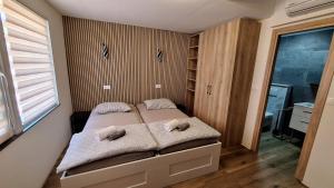 a bedroom with a bed with two stuffed animals on it at Sleep House in Labin