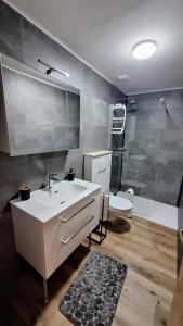 a bathroom with a sink and a tub and a shower at Sleep House in Labin