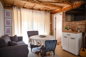 a living room with a table and a couch at Etno kuca Drina in Loznica