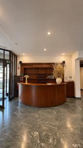 a lobby with a reception desk in a building at Hotel Lucija in Most na Soči