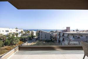 a balcony with a view of a city at Solianna Rethymno Suites in Rethymno