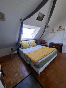 a bedroom with a bed in a attic at Villa Cap Avalenn in Fouesnant