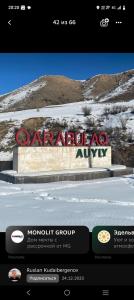 a sign for a car dealership in the snow at House Ali in Chirganak