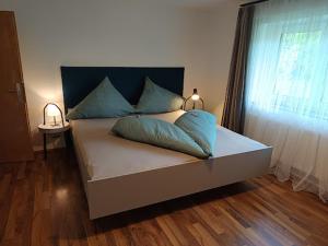a bedroom with a large bed with a window at Lodge Ehrenberg in Ehenbichl