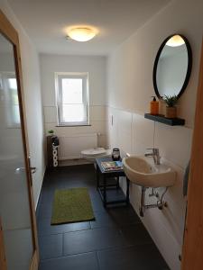 a bathroom with a sink and a mirror at Lodge Ehrenberg in Ehenbichl +62 photos