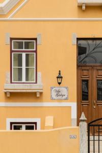 a yellow building with a window and a door at Villa Galega in Santa Cruz