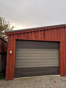 a garage with a large metal garage door at Cardrona Alpine Luxe in Cardrona +7 photos