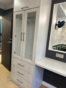 a bathroom with a white cabinet and a mirror at Guest Room Star Avenue in Shah Alam