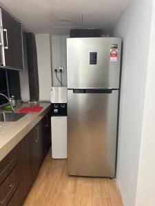 a stainless steel refrigerator in the corner of a kitchen at Guest Room Star Avenue in Shah Alam