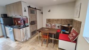 a small kitchen with a table and a refrigerator and a counter at Gîte Lydmalida cocon Ardéchois in Les Ollières-sur-Eyrieux +22 photos