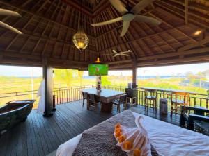 a room with a table and a dining room with a television at Beachview Villa near Sanur, Live Sports AFL NRL in Ketewel